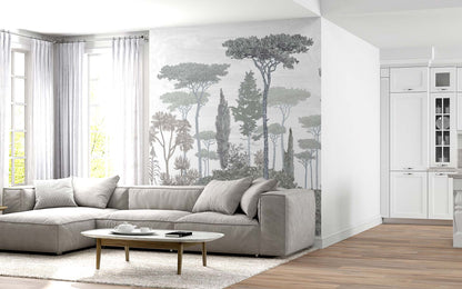 Modern living room with a light gray sectional sofa, oval wooden coffee table, tree mural wall, and white cabinetry.