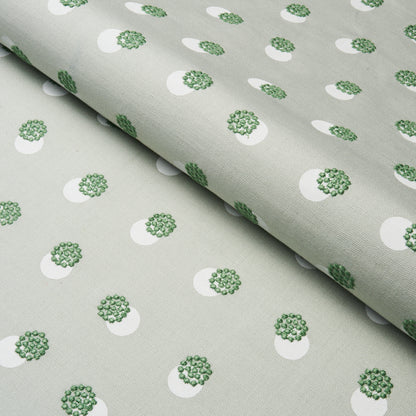Light grey woven fabric with white circular motifs containing green floral clusters; subtle repeating pattern.