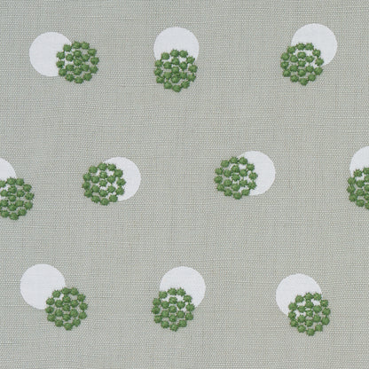 Beige linen-like fabric with white circles & green floral rosettes; retro botanical print for upholstery.