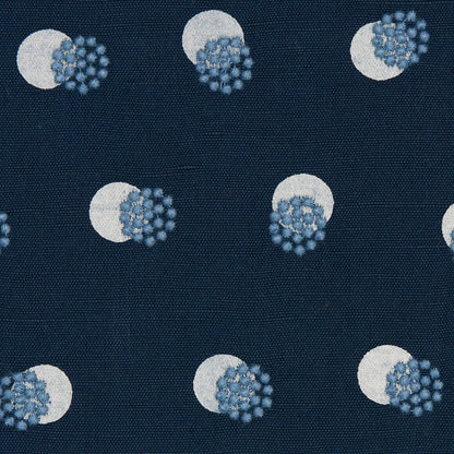 Navy fabric featuring repeating white circles overlapped by blue spiky virus-like clusters on a woven backdrop.