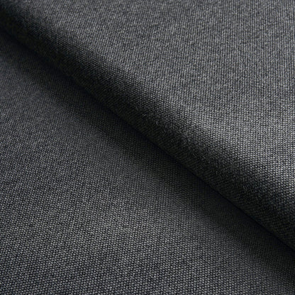 Close-up of charcoal gray woven fabric with a folded edge, fine twill texture suitable for suits.