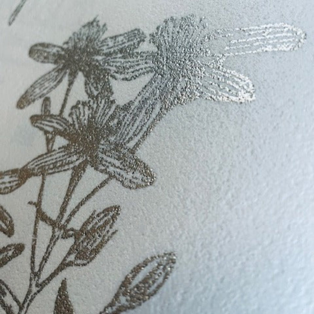 Silver metallic botanical wallpaper — hand‑drawn sketch foliage motif, luminous finish, non‑woven paste‑the‑wall for easy installation and removal, ideal for accent walls in elegant interiors