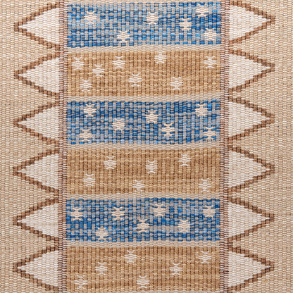 Woven kilim rug with alternating blue and tan horizontal bands, white diamond motifs, chevron side border.