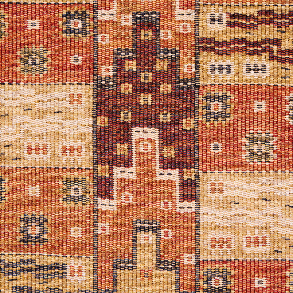 Handwoven wool kilim rug with patchwork squares in warm orange, cream and brown; geometric motifs and central dark cross.