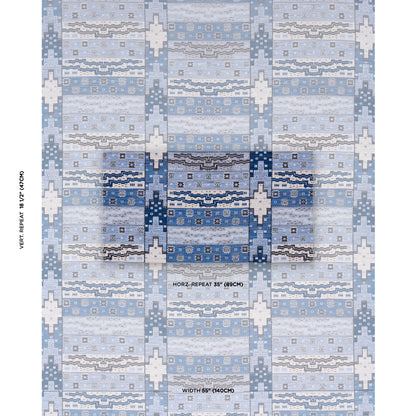 Blue and white geometric patterned rug with repeating cross motifs and wavy bands; soft contemporary floor decor.