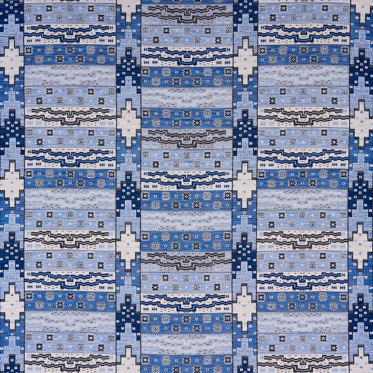 Blue woven rug with light to dark blue stripes, white geometric diamonds and small floral motifs.