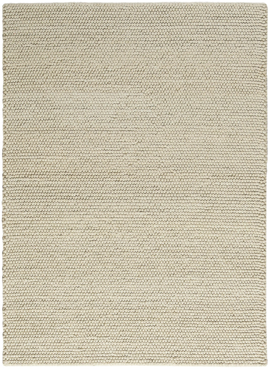 Beige textured rug close-up with tight loop pile; rectangular, minimalist home decor.