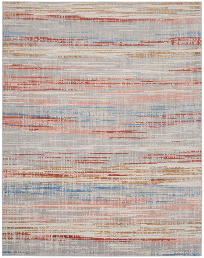 Abstract area rug with irregular horizontal stripes in orange, red and blue on a light gray background.