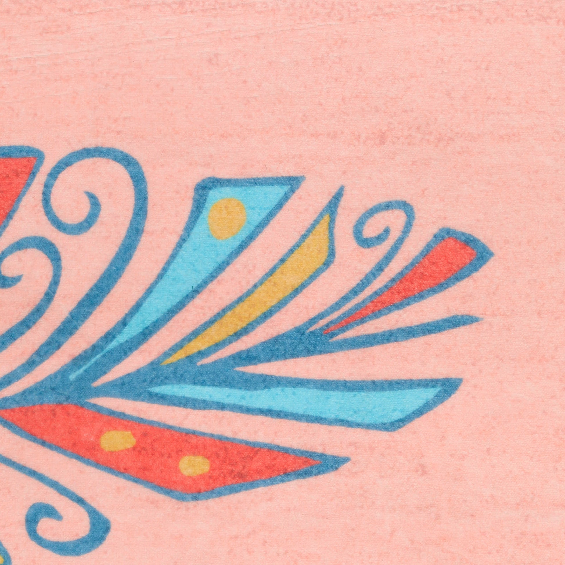 Close-up of pink rug with a bright tropical feather pattern in blue, teal, yellow and orange.