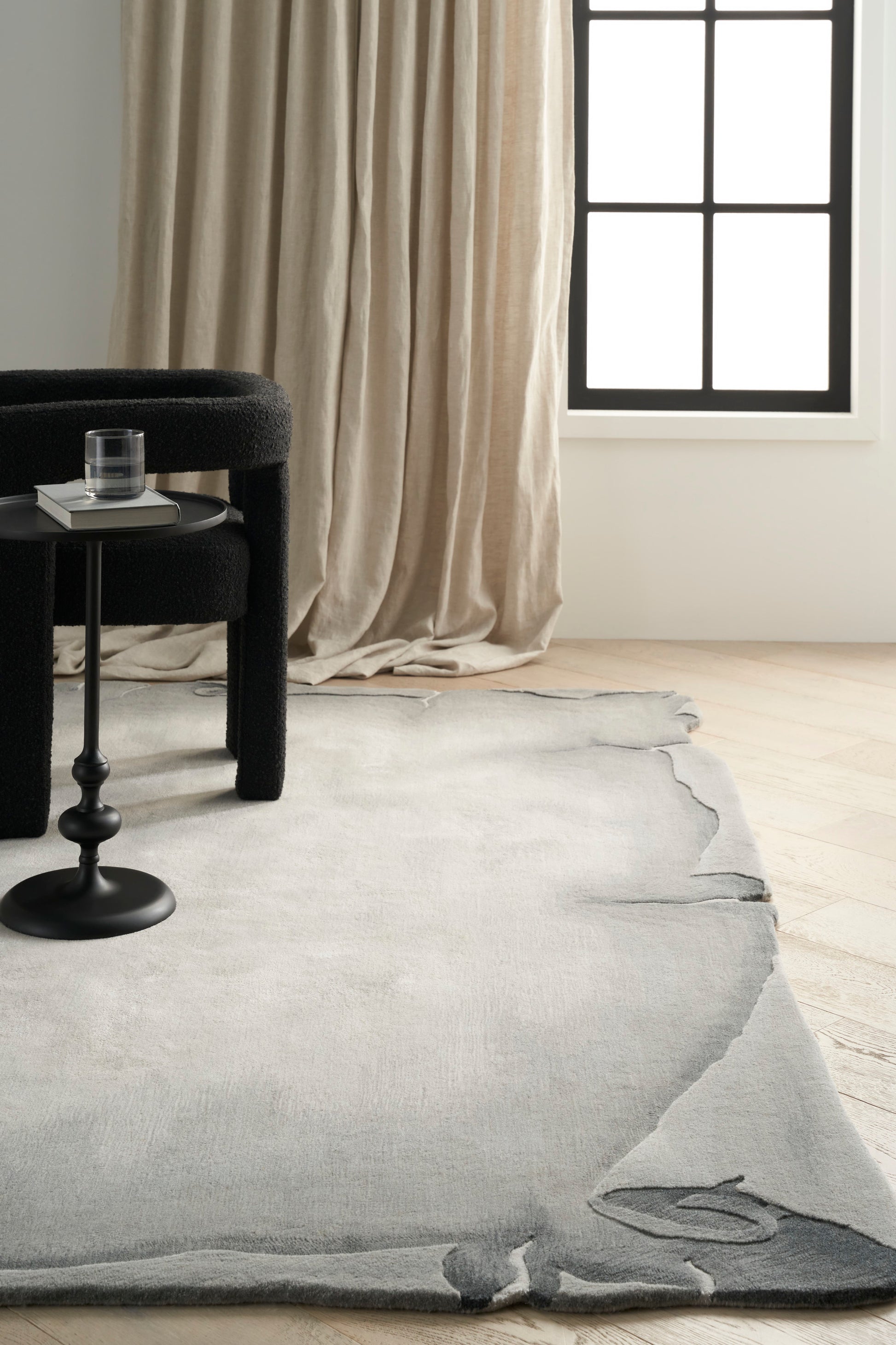 Gray 8' x 10' area rug on light wood floor, modern style.