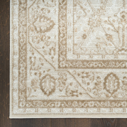 Cream and taupe oriental area rug with medallion and ornate border on dark wood floor.