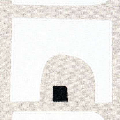 Beige fabric with white geometric panels and a small black square, modern abstract textile for decor.