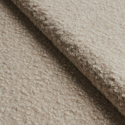 Beige boucle wool fabric with soft fuzzy texture and folded edge.
