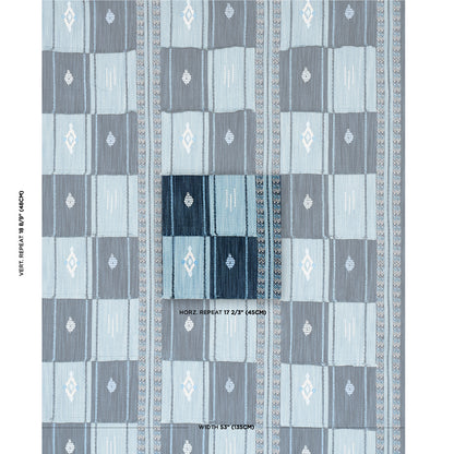 Blue geometric quilted textile with alternating light/dark blue squares and diamond motifs; decorative rug or throw.