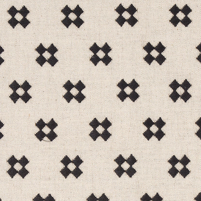 Cream natural fabric with repeating black X-shaped embroidery motifs forming a geometric grid.