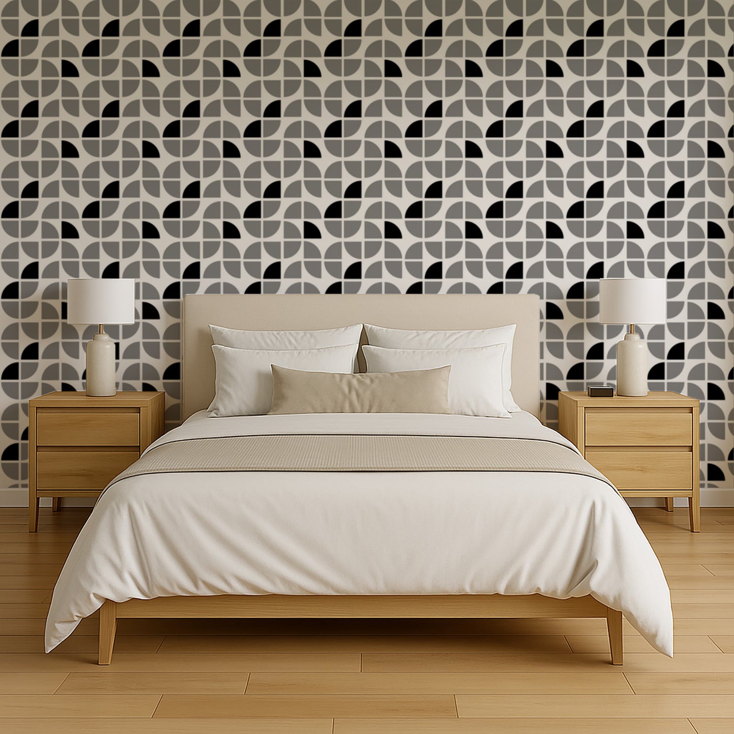 Queen bed with white and beige bedding, two wooden nightstands and lamps, set against gray geometric wallpaper.