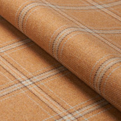 Orange wool plaid fabric rolled at the edge with beige stripes in a soft textured weave.