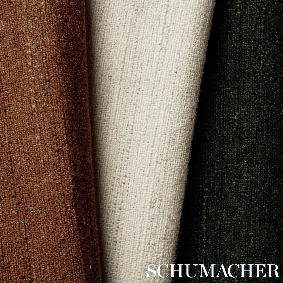 Three woven fabric bolts in ivory with brown and dark green accents; textured tweed-style upholstery fabric.