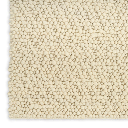 Cream textured shag rug with dense round tufted pile; plush neutral beige, rectangular for living room or bedroom.