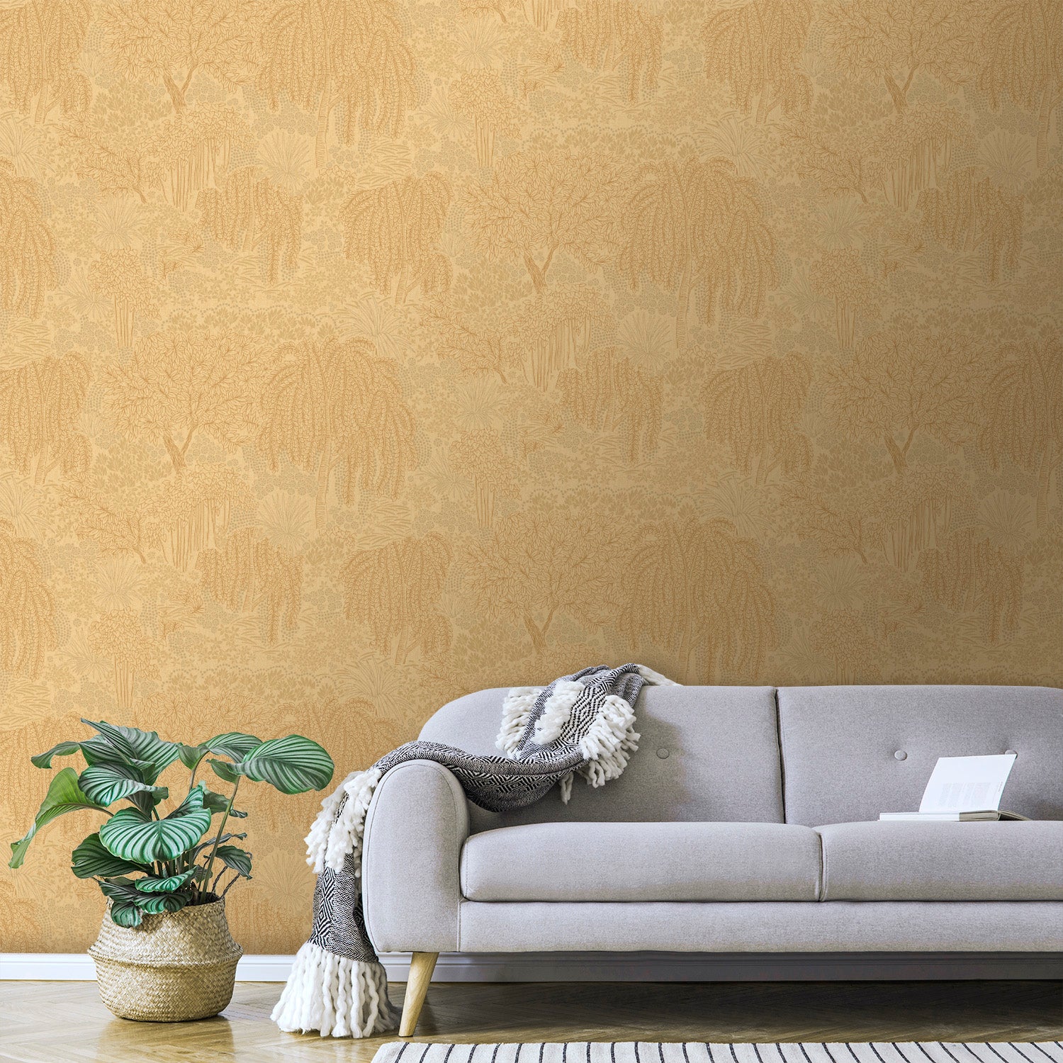 Orange palm-pattern wallpaper visible in a room with a beige mid-century sofa, grey cushions, a fringed throw, and a monstera plant in a woven basket.