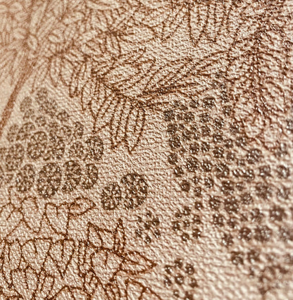 Tan wallpaper with a dark brown damask floral pattern and a textured embossed surface