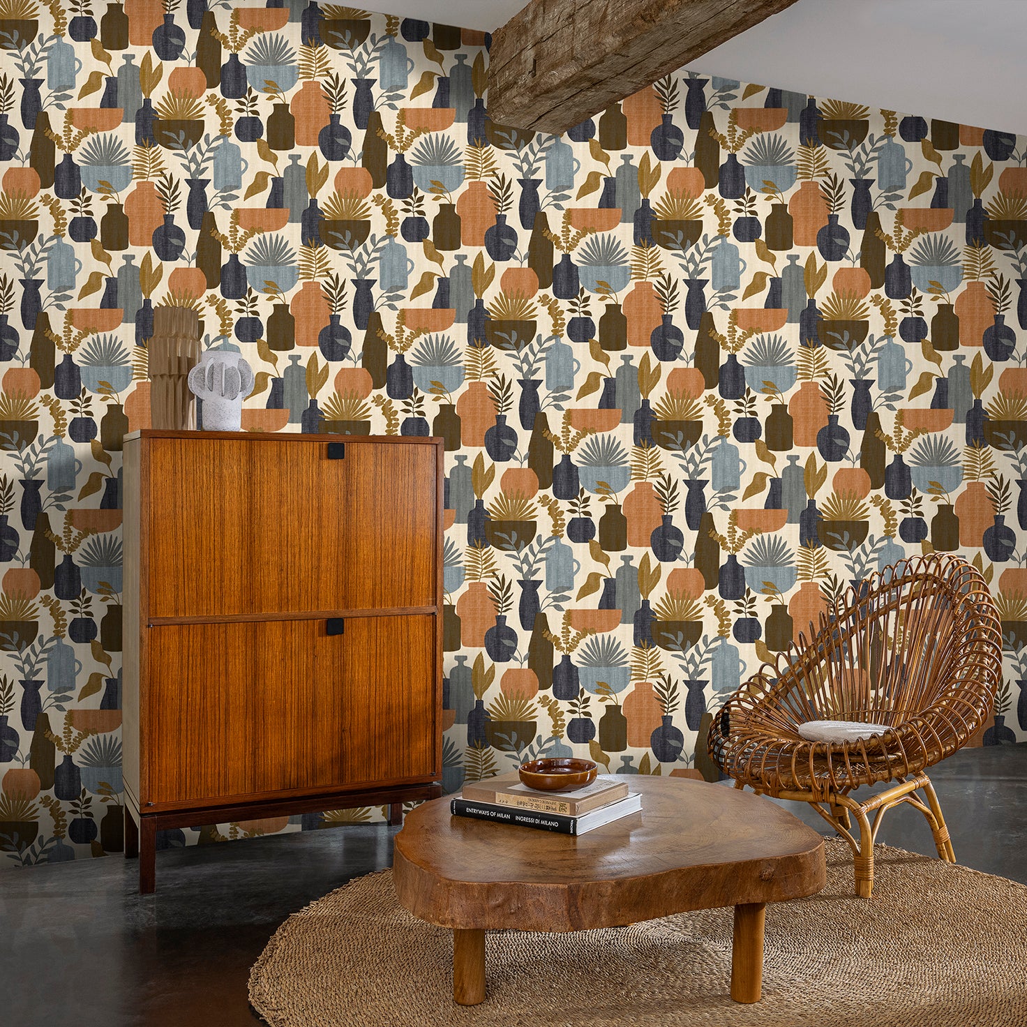 Mid-century living room with bold botanical wallpaper in earthy tones; wood cabinet, live-edge coffee table, wicker chair, and jute rug.