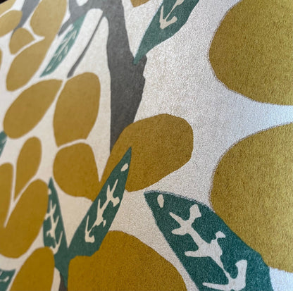 Citron wallpaper featuring layered tropical leaves in yellow and gold tones; non-woven wallcovering suitable for bright accent walls or modern interiors.