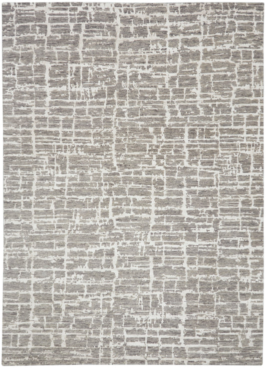 Rectangular gray and ivory textured area rug with an abstract brick-like pattern, modern living room decor.