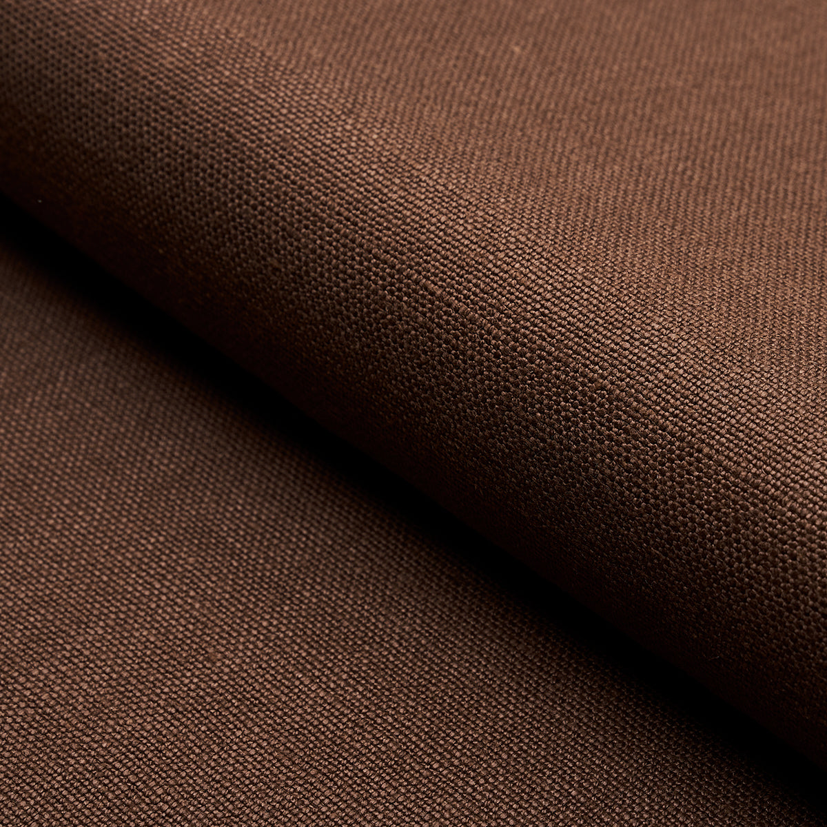 Brown linen fabric folded; tight weave with matte finish, versatile textile for apparel or home decor.