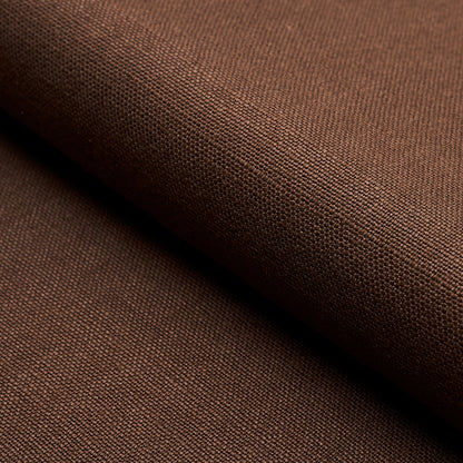 Brown linen fabric folded; tight weave with matte finish, versatile textile for apparel or home decor.