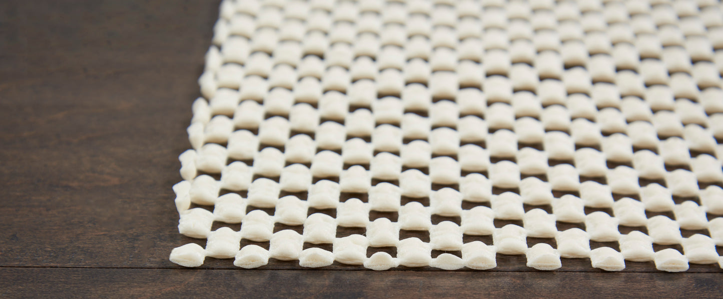 Cream rug with square lattice pattern on dark wood surface