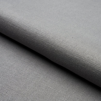 Gray woven fabric with fine texture, folded edge, suitable for upholstery or apparel.