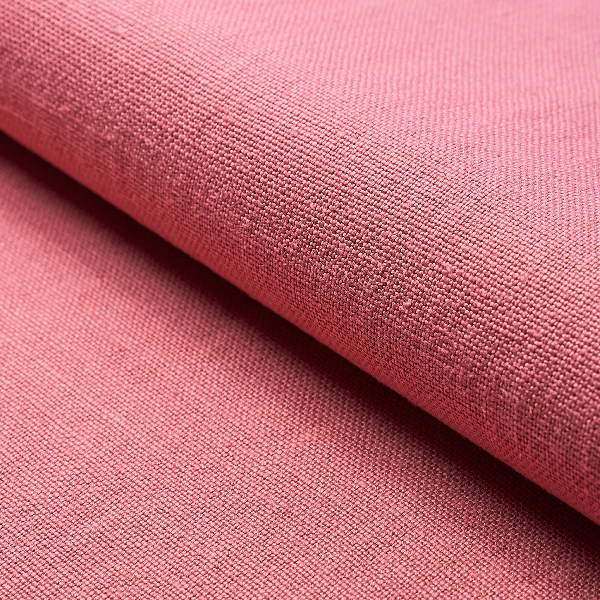 Soft pink woven fabric close-up with visible weave, folded edge; suitable for crafts or home decor.