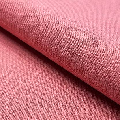 Soft pink woven fabric close-up with visible weave, folded edge; suitable for crafts or home decor.