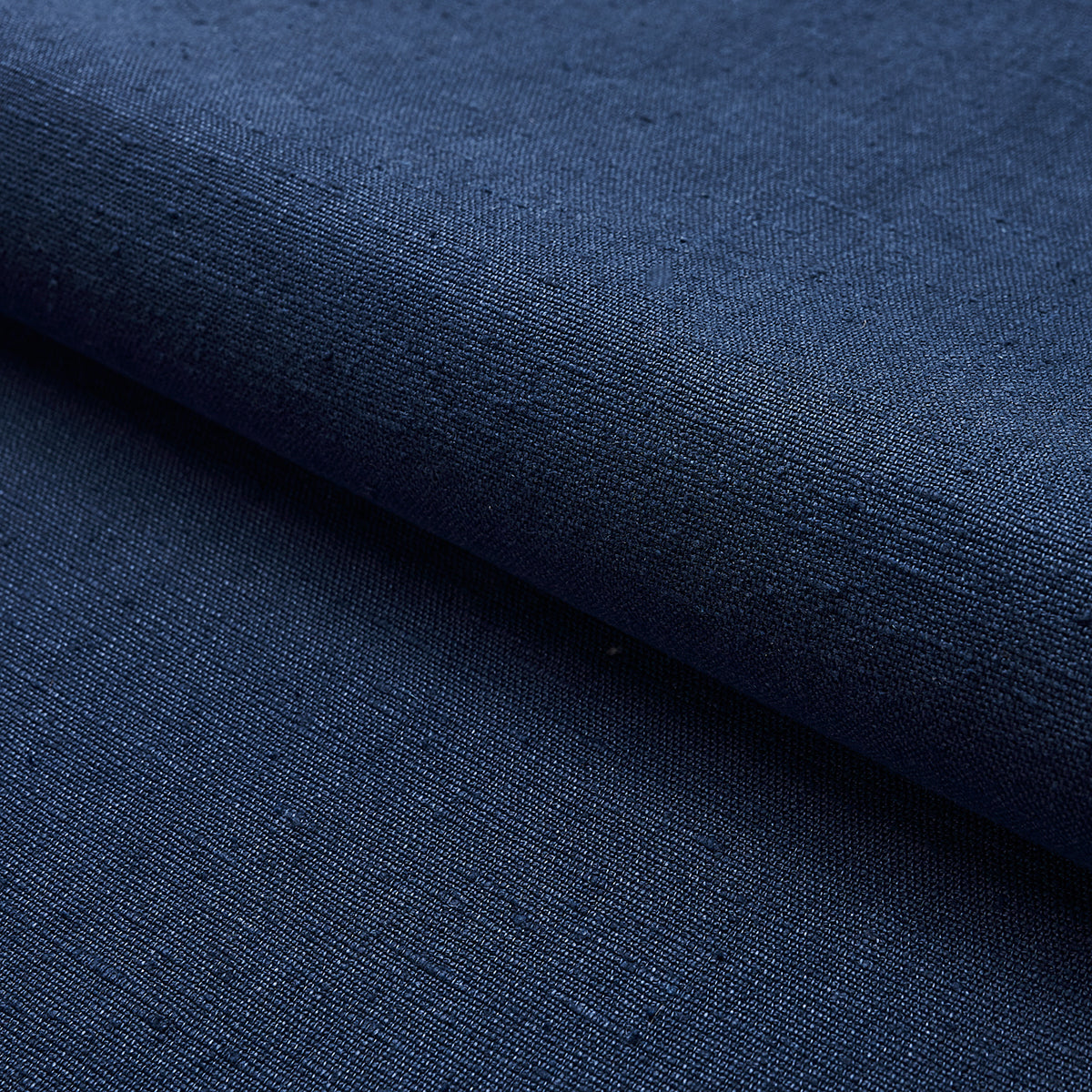 Dark navy blue woven fabric with subtle texture, folded edge; versatile denim-style cotton.