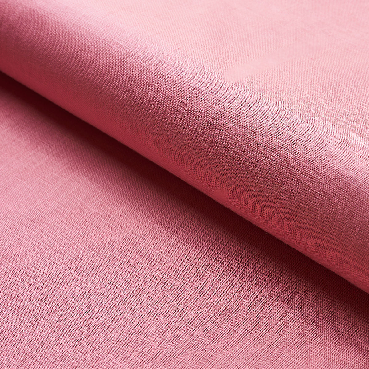Soft pink linen-like fabric, folded edge, fine weave texture; great for garments or home decor.