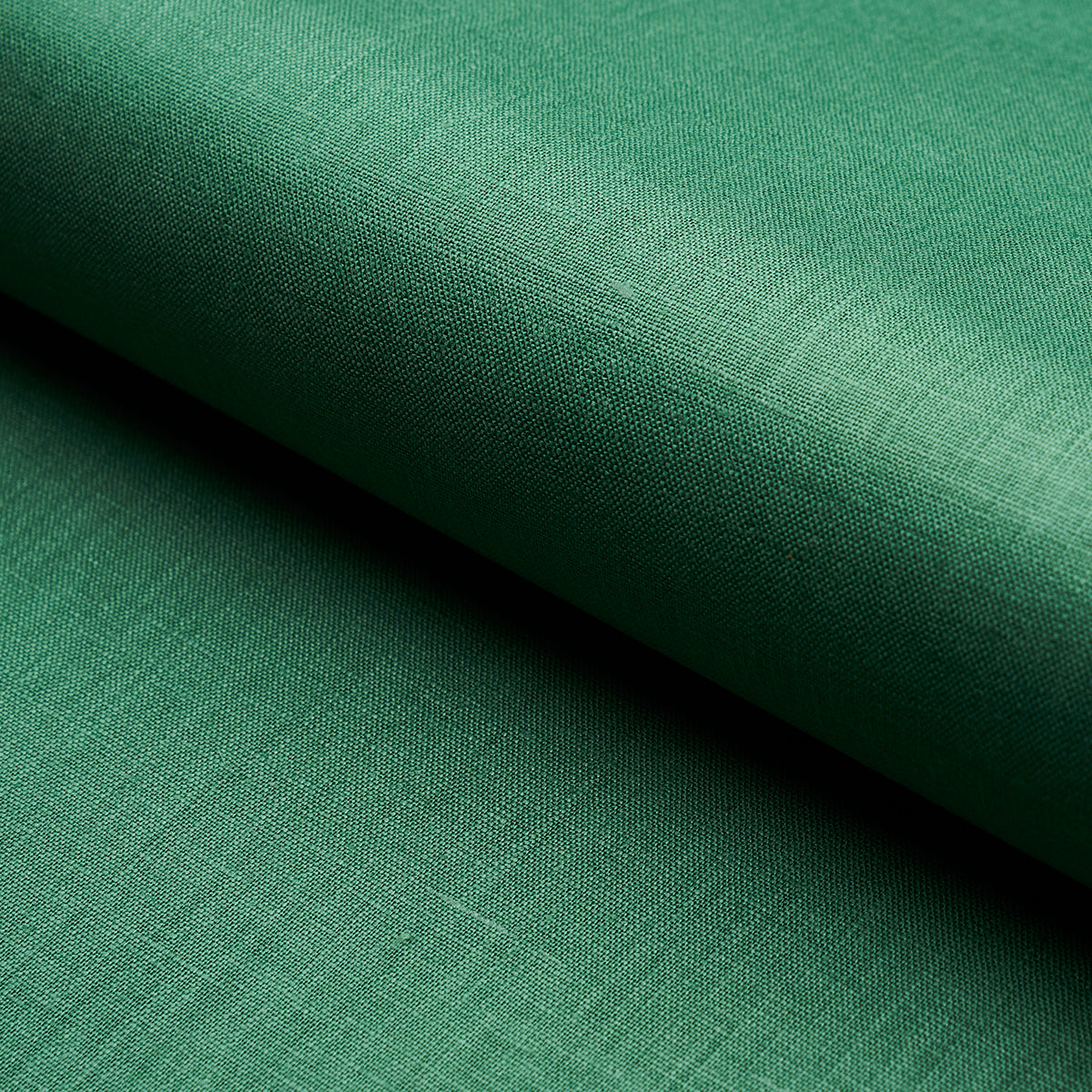 Green linen-like fabric rolled, close-up weave texture with soft matte finish.