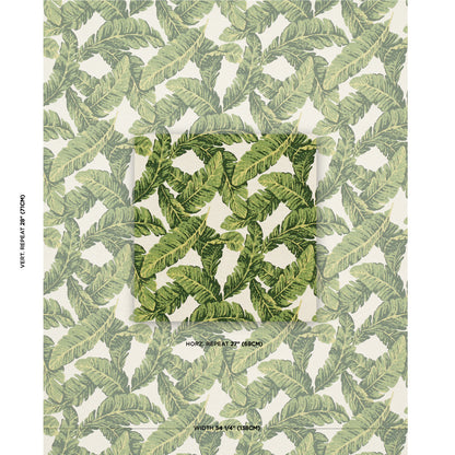 Green banana leaf wallpaper with repeating tropical leaves on cream; darker circular swatch center.