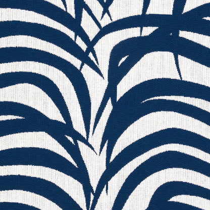 Bold navy palm-leaf botanical print on white fabric; curved stripe pattern suitable for curtains or cushions.