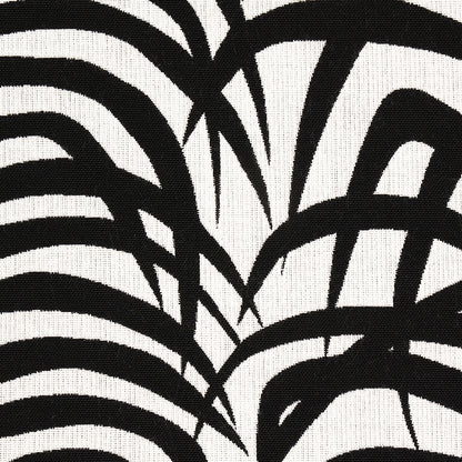 Abstract black brushstroke pattern on cream fabric; zebra-inspired geometric textile design.