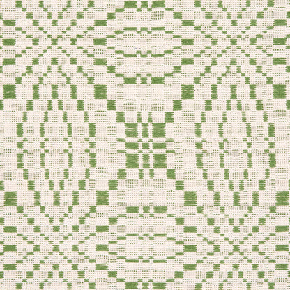 Green geometric damask-inspired woven fabric with oval/diamond lattice and a leaf motif on cream background; coverlet pattern woven fabric.