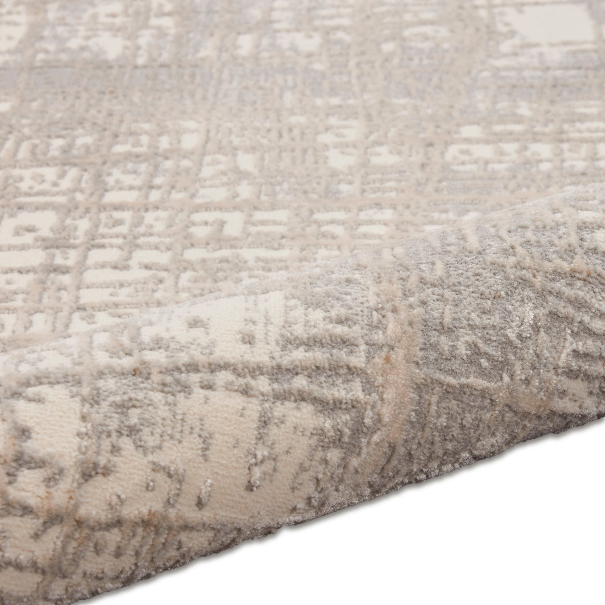 Beige and taupe patterned modern runner rug with plush pile and folded edge, geometric distressed motif.