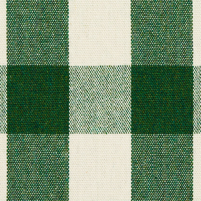 Green and cream plaid woven fabric with dark and olive-green squares; checker pattern for apparel or home decor.
