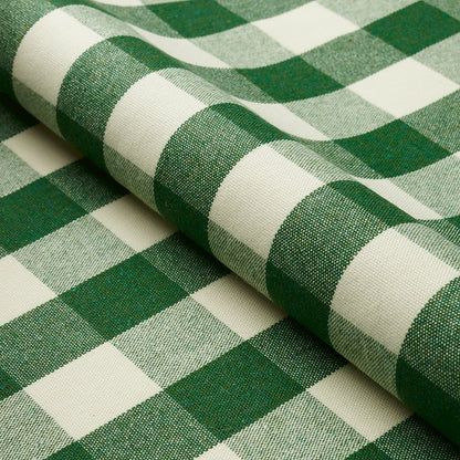 Green and white gingham check fabric, rolled, cotton-like material, ideal for tablecloths or crafts.