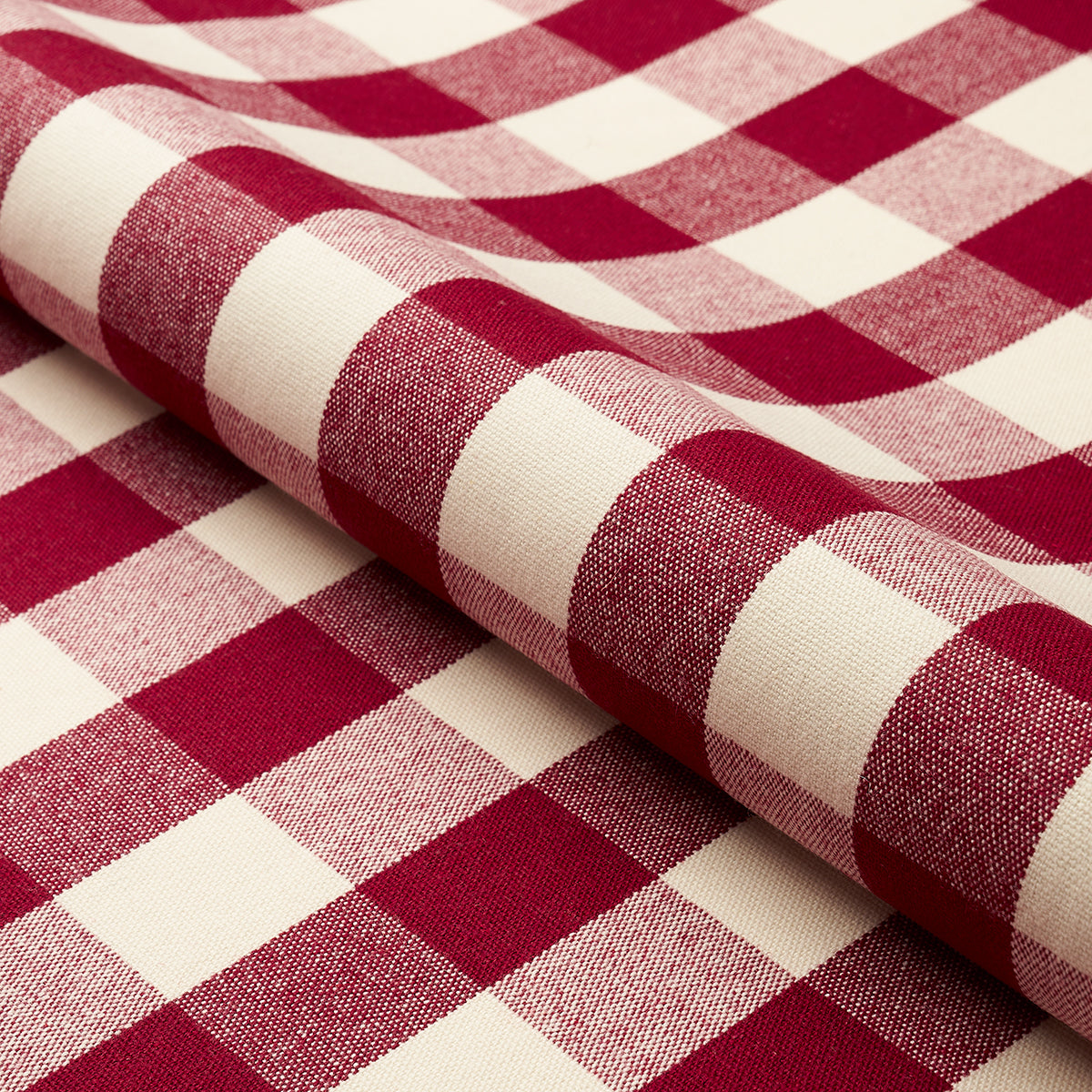 Rolled red and white gingham fabric with classic checkered pattern and soft woven texture.