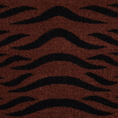 Brownish-red rug with bold black wavy tiger-stripe pattern; plush textured fabric.