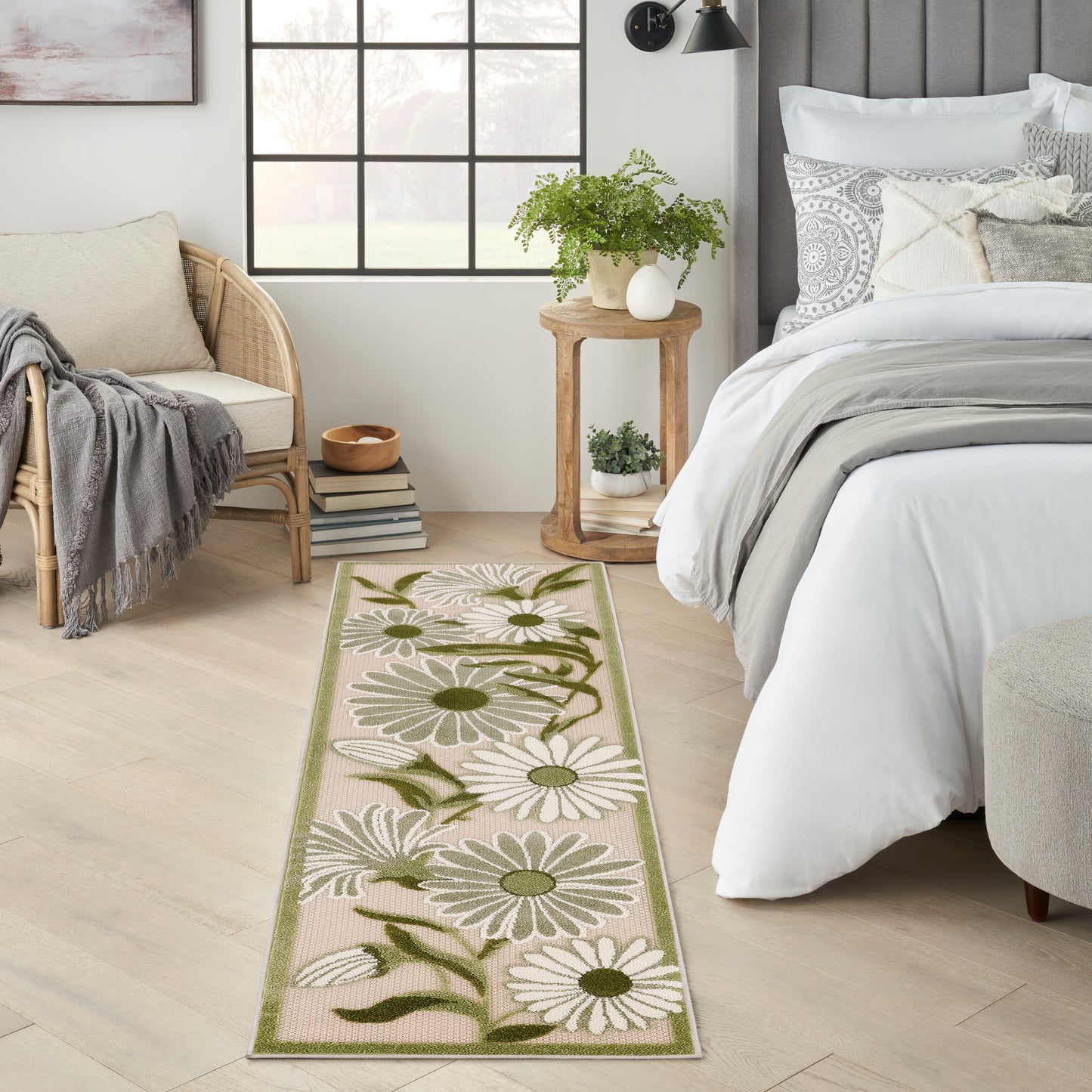 Long beige floral outdoor runner rug with white daisies, green leaves & a green border.