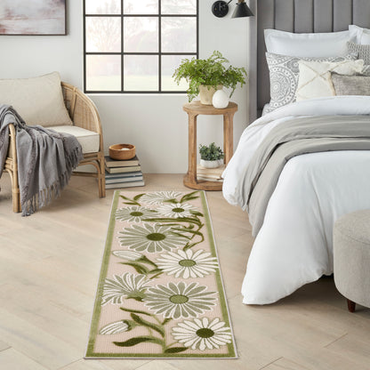 Long beige floral outdoor runner rug with white daisies, green leaves & a green border.