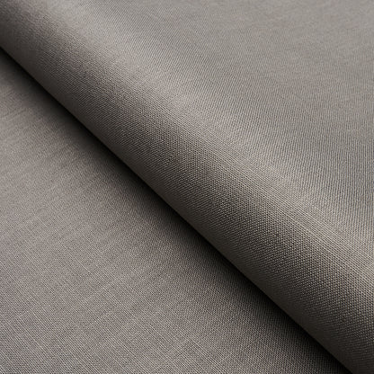 Taupe-gray woven fabric with tight texture, folded drape; versatile upholstery or apparel material.