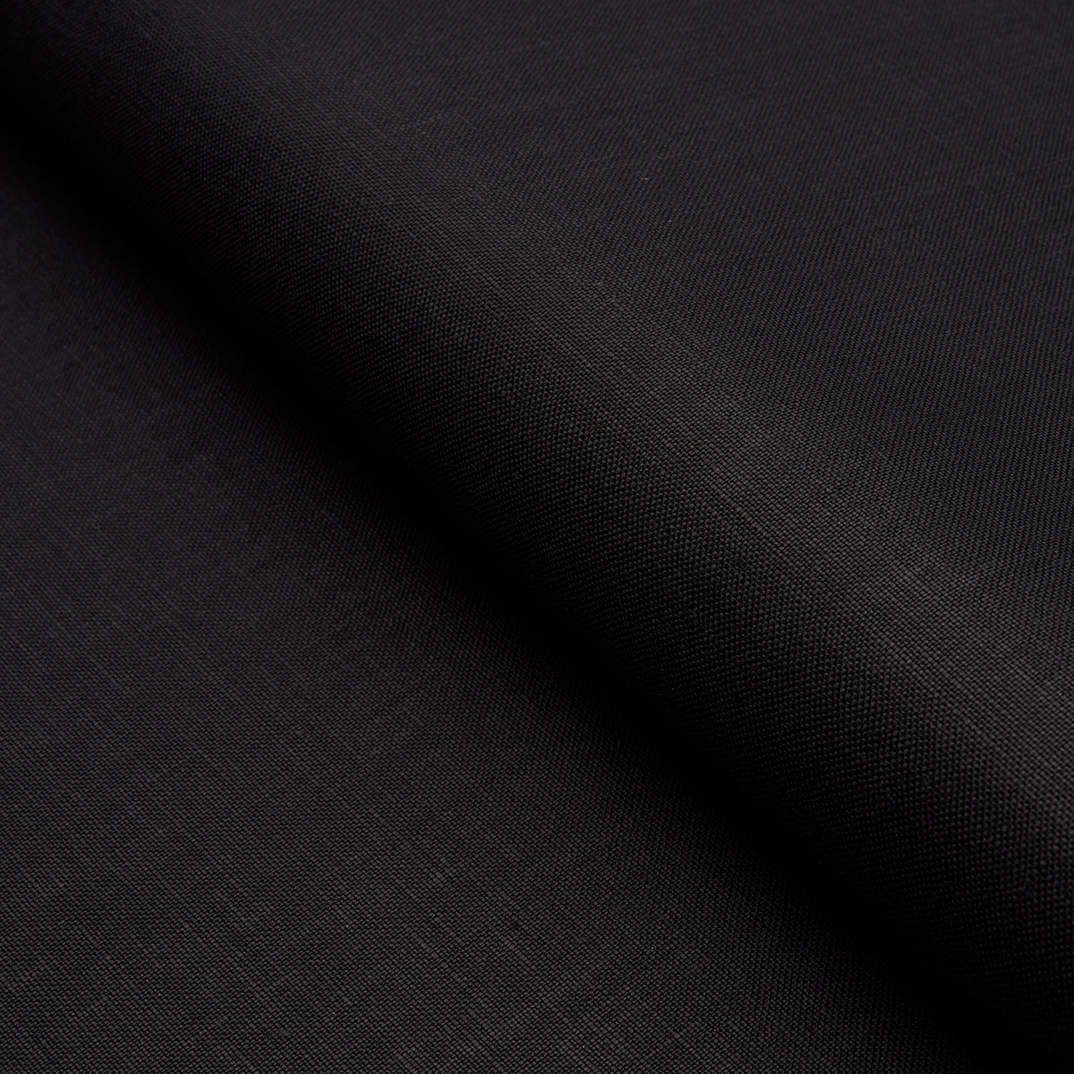 Black fabric with smooth matte weave and diagonal fold; versatile for clothing or upholstery.